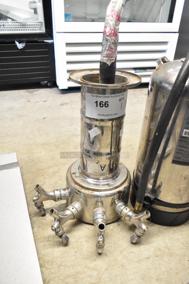 Commercial metal 4 tap beer tower with hoses, auction tag "166," shows light wear. Ideal for bar setups.