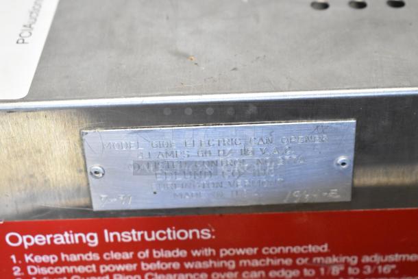 Edlund 610E Stainless Steel Can Crusher, electric, 115V, 1 phase, metal tag with model details, operating instructions visible.
