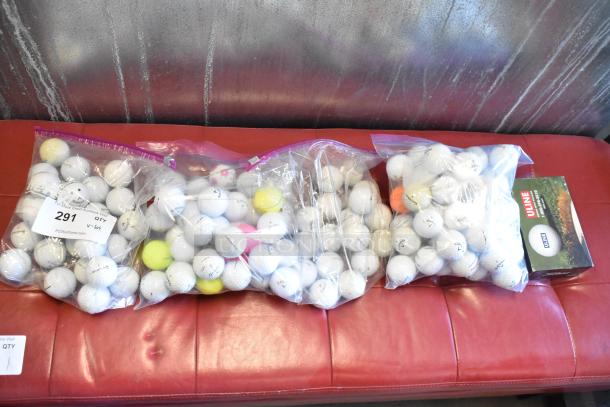 Lot of various golf balls in ziplock bags, including TaylorMade and Callaway brands. Items appear in used condition.