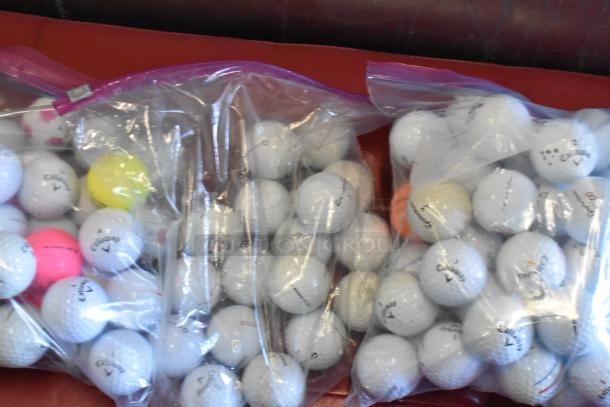Lot of mixed golf balls in ziplock bags, featuring brands like TaylorMade and Callaway, various colors, good condition.