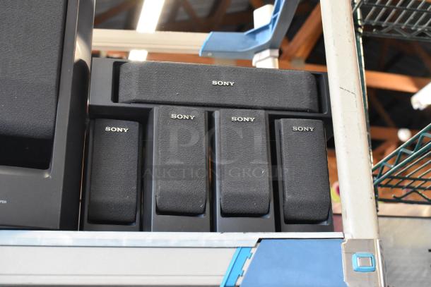 Sony speaker set, five pieces, uniform black design with Sony logo, appears in good condition, shelf display.