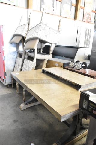 Wooden dining table with six stacked chairs, featuring ornate legs and a natural finish. Excellent condition, ideal for dining rooms.