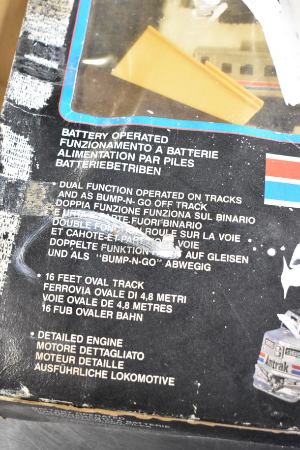 Amtrak 6042 Toy Train box with dual-function battery operation and 16 ft oval track detail shown. Box has wear and markings.