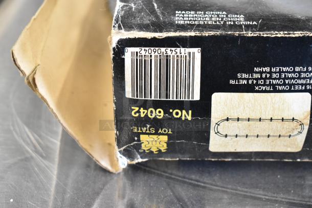 Amtrak 6042 Toy Train packaging showing wear, original barcode, and "Made in China" label on black box.