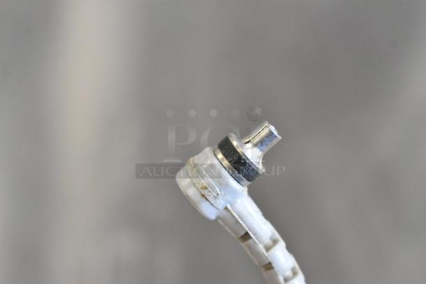 Halina 1:5.6 film camera and Honeywell Tilt-a-mite gauge; close-up of camera part, minor wear visible.