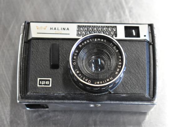 Halina 300 film camera with 1:5.6 Anastigmat lens. Features include 45mm focal length and visible I26 marking.