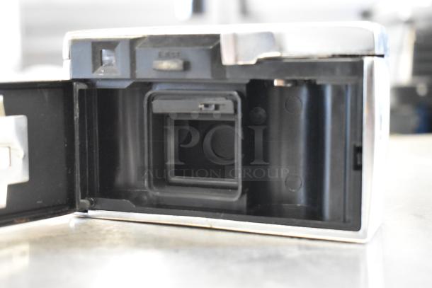 Open back view of a Halina 1:5.6 film camera, showing film compartment; appears clean, indicative of light use.