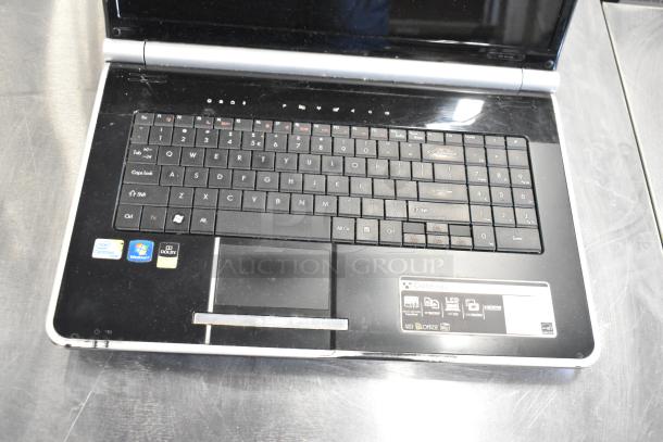 Gateway KAYF0 laptop featuring Intel Centrino and Windows 7 stickers. Display hinges, keyboard, and multimedia buttons visible.