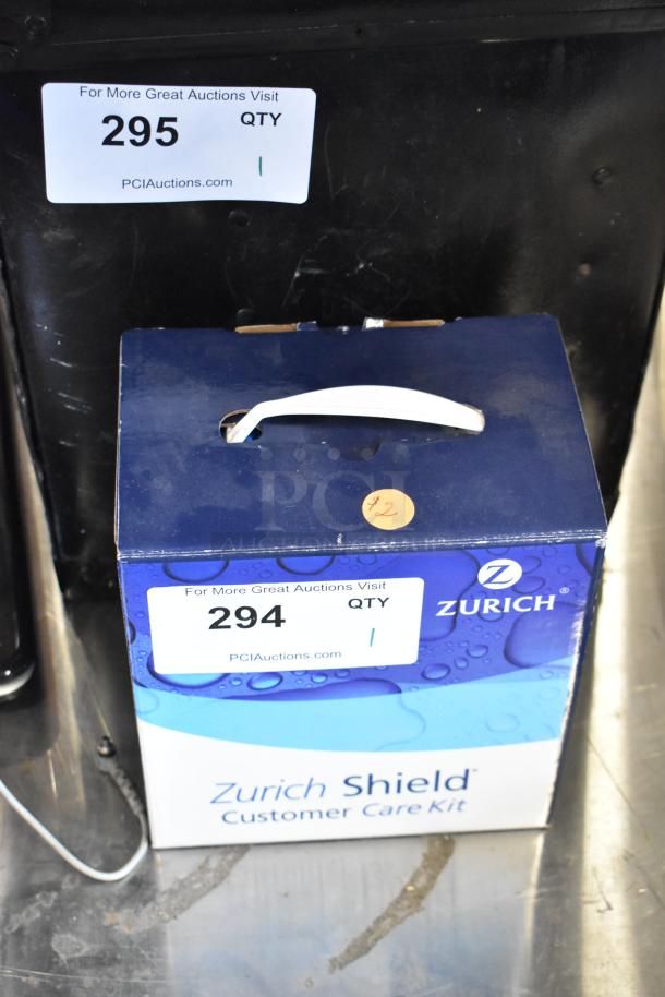 Zurich Shield Customer Care Kit box with handle, auction label 294, and $2 sticker. Box in good condition.