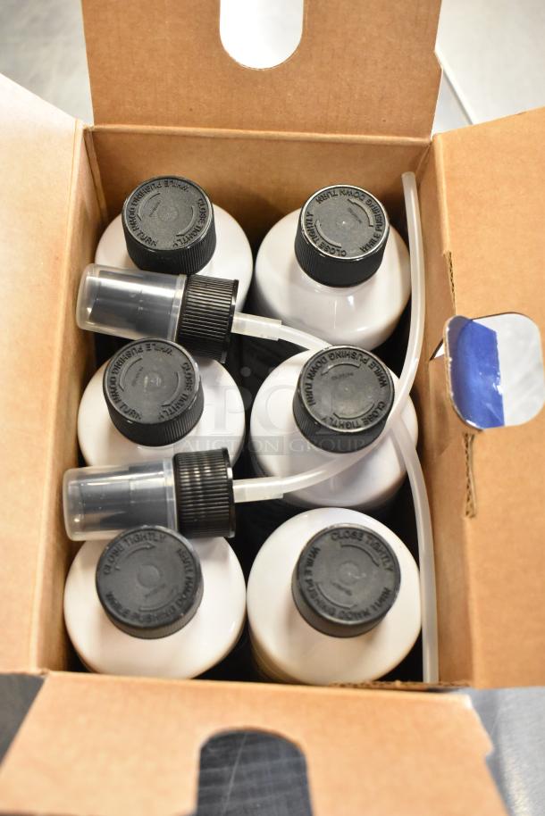 Zurich Shield Customer Care Kit with several white bottles, black caps, and spray nozzles in a cardboard box, new condition.