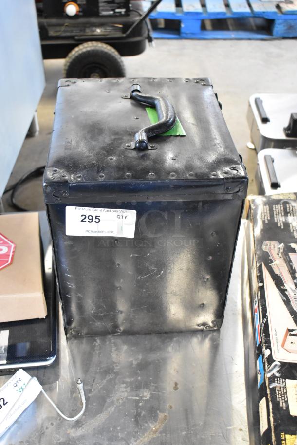 Black metal hard case with handle, housing Humble Film Library Films. Shows wear. Auction tag number 295 visible.