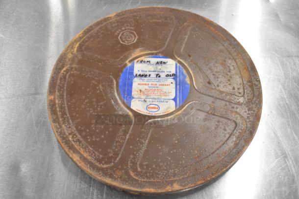 Rusted film canister containing "From New Lands to Old," 16mm sound color film, Humble Film Library label.