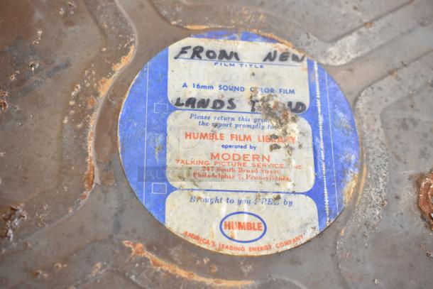 Weathered film case featuring Humble Film Library label, including "From New Lands" film, 16mm sound color, by Modern Talking Picture Service.