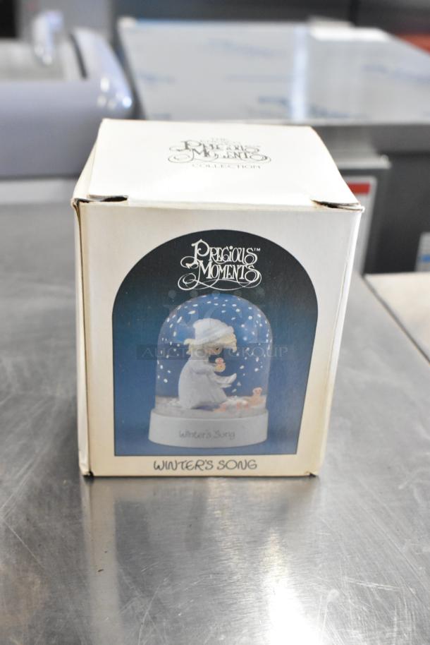 Precious Moments "Winter's Song" figurine in original box, pristine condition; features a child in winter attire.