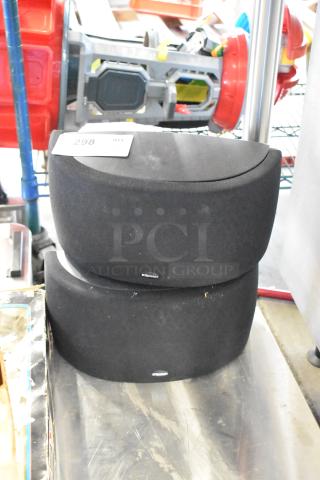 Two Klipsch speakers in black fabric, stacked. Slight wear. Tag indicating quantity: 2. Ideal for enhancing audio setup.