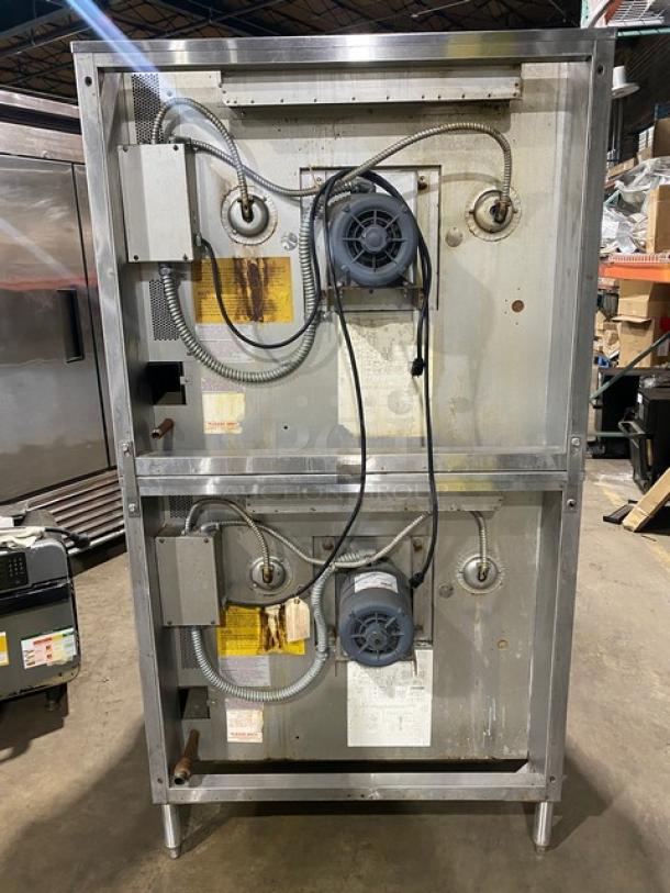 Blodgett double-stacked stainless steel convection oven, natural gas powered, with wired racks, on legs. Industrial setting.