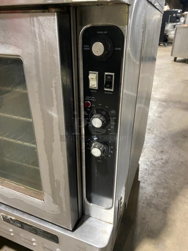 Blodgett stainless steel double-stacked convection oven, natural gas, with wired racks, control panel, on sturdy legs.