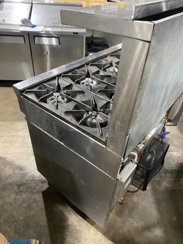 U.S. Range commercial 10-burner stainless steel gas range with double oven, backsplash, salamander shelf, on casters, wired racks.