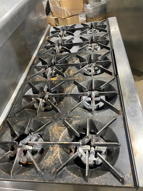 U.S. Range commercial stainless steel 10 burner range, double oven combo with backsplash, overhead salamander shelf, and casters.