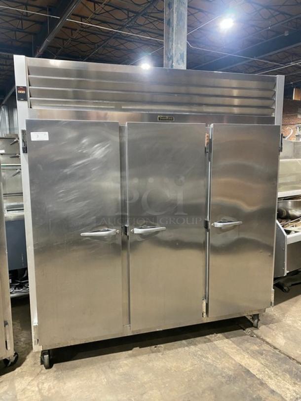 Traulsen G31010 stainless steel triple-door reach-in freezer with poly-coated racks, on casters. Model SN: T55994F07, 115V.