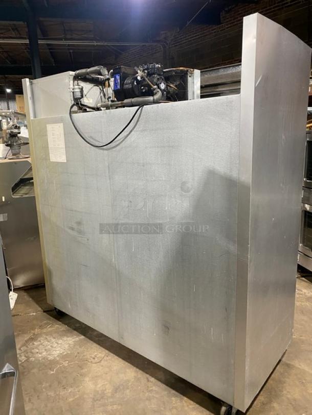 Traulsen commercial stainless steel triple door freezer, model G31010, with poly coated racks, 115V, on casters, visible wiring.