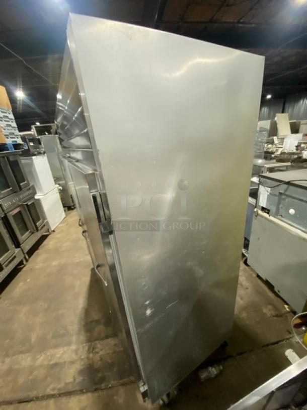 Traulsen G31010 commercial stainless steel triple door reach-in freezer with poly-coated wired racks, on casters.