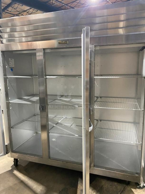 Traulsen stainless steel triple-door freezer, Model G31010, with poly-coated wire racks, on casters, 115V 1 Phase.