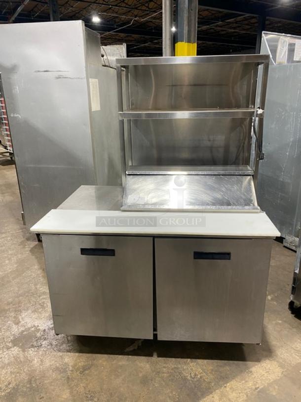 Randell stainless steel 2-door refrigerated prep table, model 9303-7, with double overhead shelf and poly-coated racks, on casters.