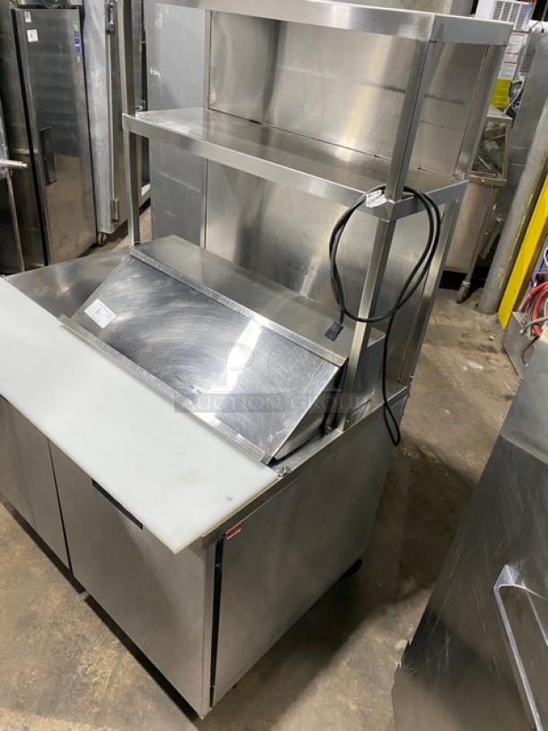 Randell stainless steel 2-door refrigerated prep table, model 93037, with overhead shelf, poly-coated racks, on casters.