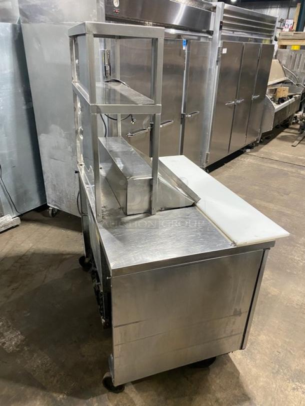 Randell 93037 stainless steel 2-door refrigerated prep table with double overhead shelf and poly-coated racks on casters.