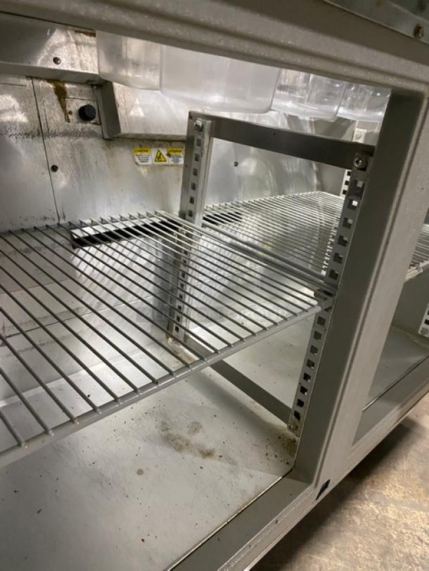 Randell 9303-7 refrigerated prep table, stainless steel, 2 doors, poly coated racks, overhead shelf, on casters, 115V, 1 phase.