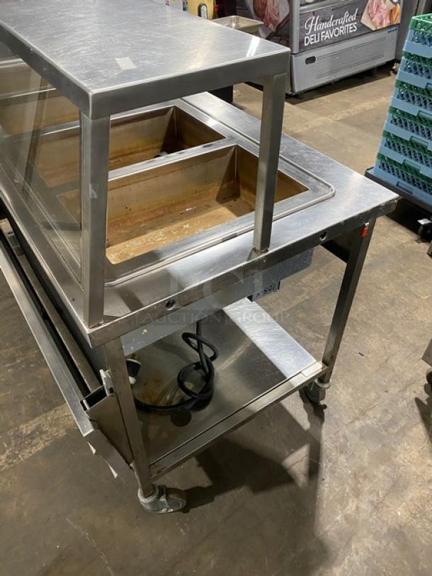 Atlas Metal WIHD&M4 stainless steel 4-well steam table with sneeze guard, electric, 208V 1 phase, on casters, SN: 14063336A.