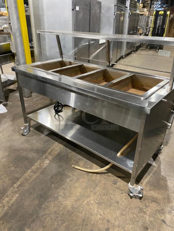 Atlas Metal stainless steel 4-well hot food table, Model WIH-D&M-4, with sneeze guard and casters, 208V, 1 phase.