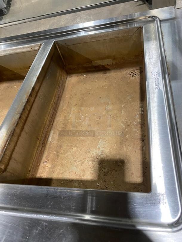 Atlas Metal stainless steel electric hot food table, Model WIH-D&M-4. Features four wells, sneeze guard, on casters. Visible wear.