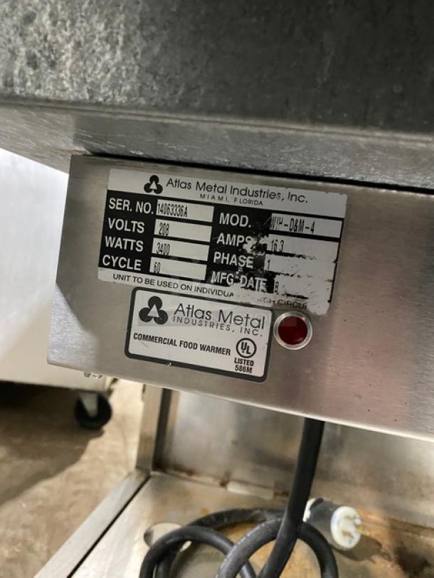 Atlas Metal commercial stainless steel electric 4-well hot food table, model WIH-D&M-4, with sneeze guard and casters.