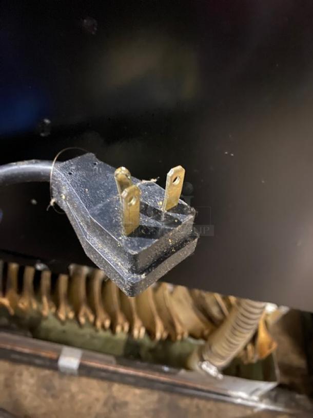 True TAC-36 black refrigerated open merchandiser plug close-up. 208-230V, 1 Phase. Good condition.