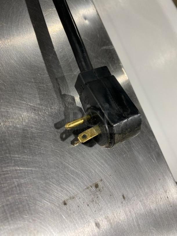 Traulsen TRP096S power plug, 115V, on stainless steel refrigerated pizza prep table surface.