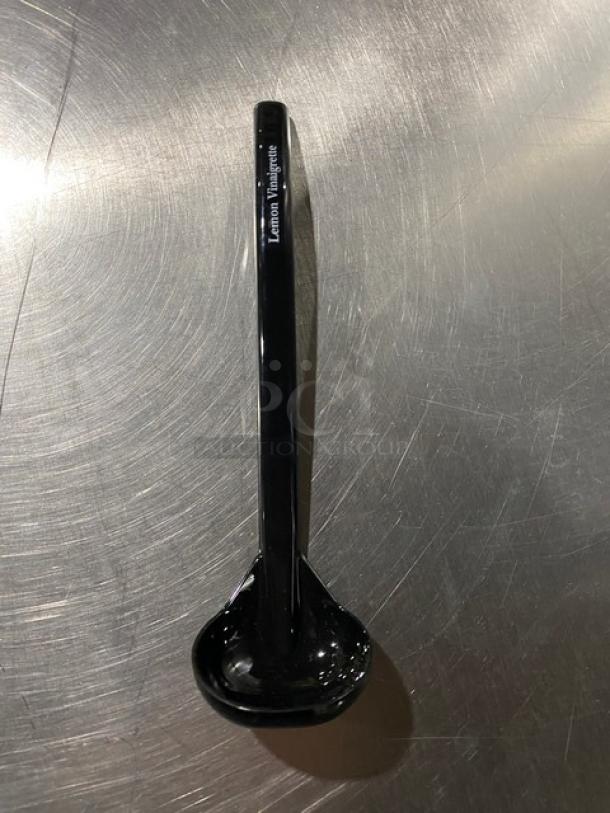 Brand new Carlisle 9.5" black lemon vinaigrette ladle, model 02955979, with "Lemon Vinaigrette" label on handle.