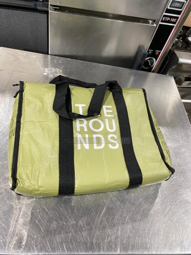 Green insulated fast food delivery bag with black straps, "THE ROUNDS" printed on front. New condition.