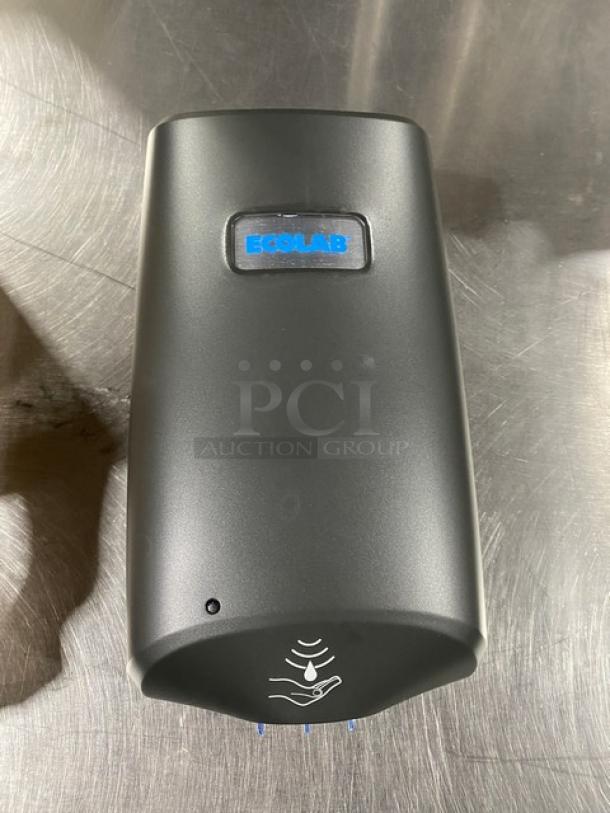 Ecolab Nexa Series black touch-free hand hygiene dispenser, new condition, features Ecolab logo and touch-free sensor icon.