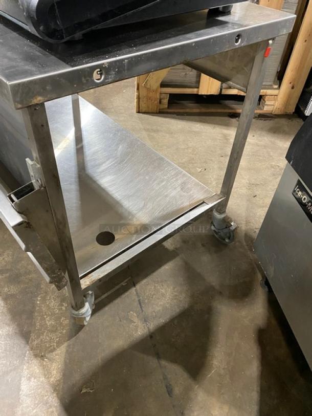 Commercial stainless steel kitchen cart with a flat top and bottom shelf, mounted on castor wheels. Good condition.