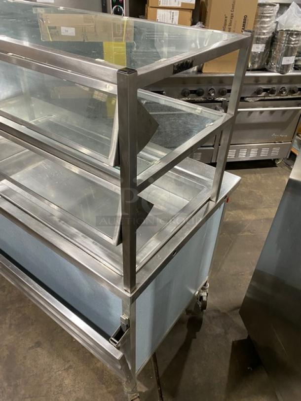 Atlas Metal stainless steel single well cold food bar with foldable tray slide, double-tier sneeze guard, on casters.