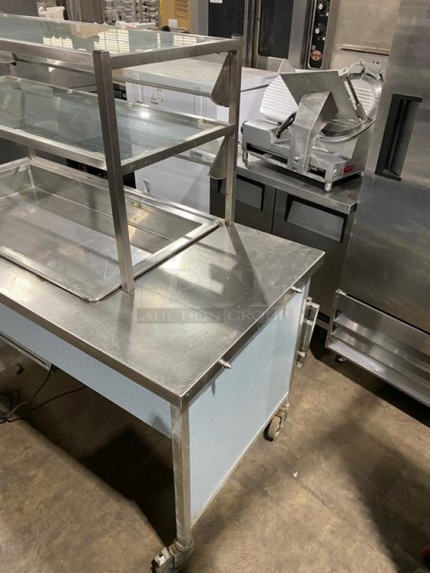 Atlas Metal commercial stainless steel cold food/salad bar with foldable tray slide, double tier sneeze guard, on casters, 115V.