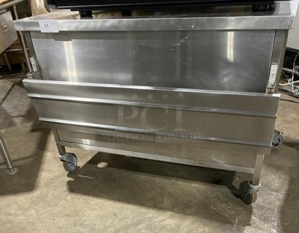 Commercial stainless steel equipment on wheels. Shiny surface, sturdy build, ideal for heavy-duty kitchen use. Good condition.