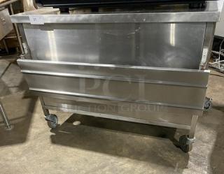 Commercial stainless steel equipment on wheels. Shiny surface, sturdy build, ideal for heavy-duty kitchen use. Good condition.