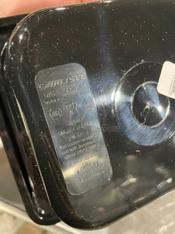 Carlisle 3068303 black 1/6-size food pan, 2.5" deep, new condition. Markings include model number and "Made in USA" label.