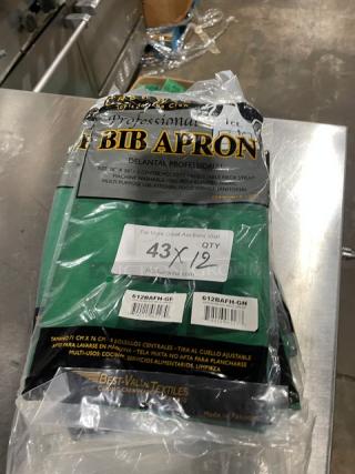 Crew Ware Professional Series green bib apron, model 612BAFH-GN, new in packaging. Features adjustable neck strap and three center pockets. Tags indicate "12X Your Bid" quantity.