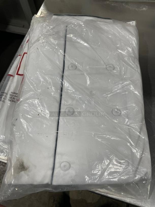 New Chefwear white chef coat, model CW5690-CWP1, M-size, black piping, packaged in plastic.