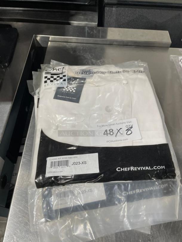 Chef Revival J023XS white classic chef jacket, new in packaging, with push-thru buttons. Model J023-XS, size XS.