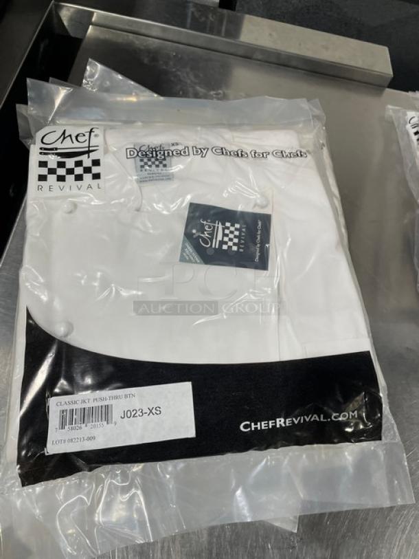 New Chef Revival white chef jacket, Model J023-XS, in packaging. Features push-thru button design, size XS.